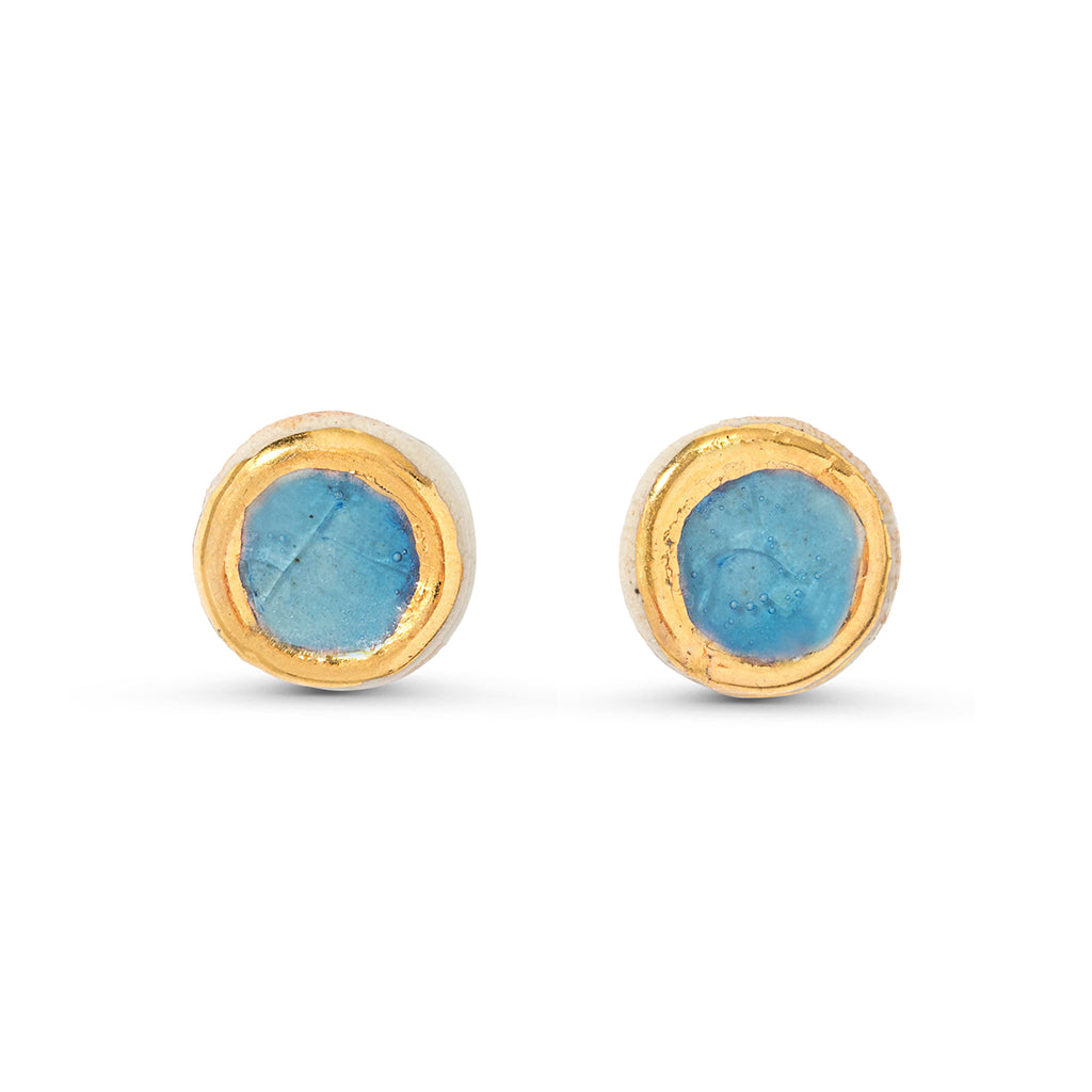 Blue glass circular stud earrings outlined in gold lustre