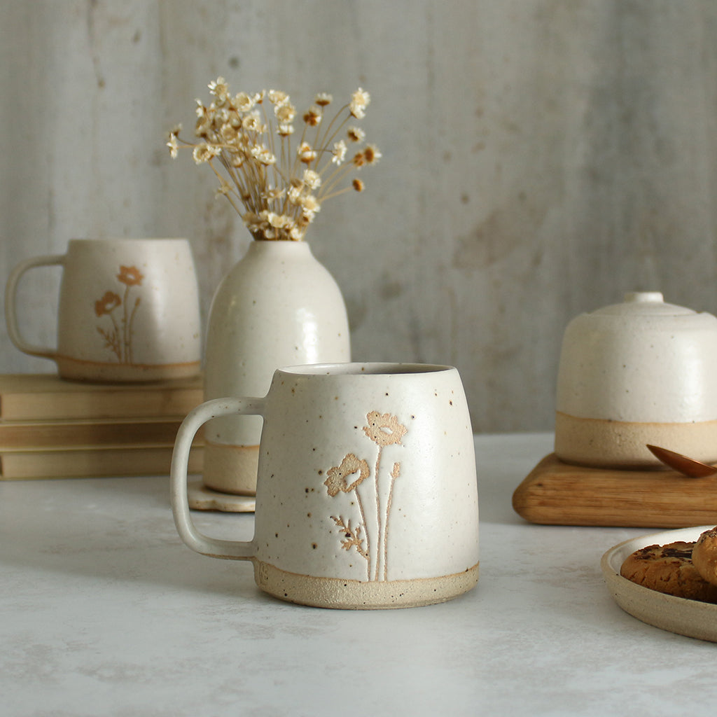 Poppy mug in front of white ceramics table setting