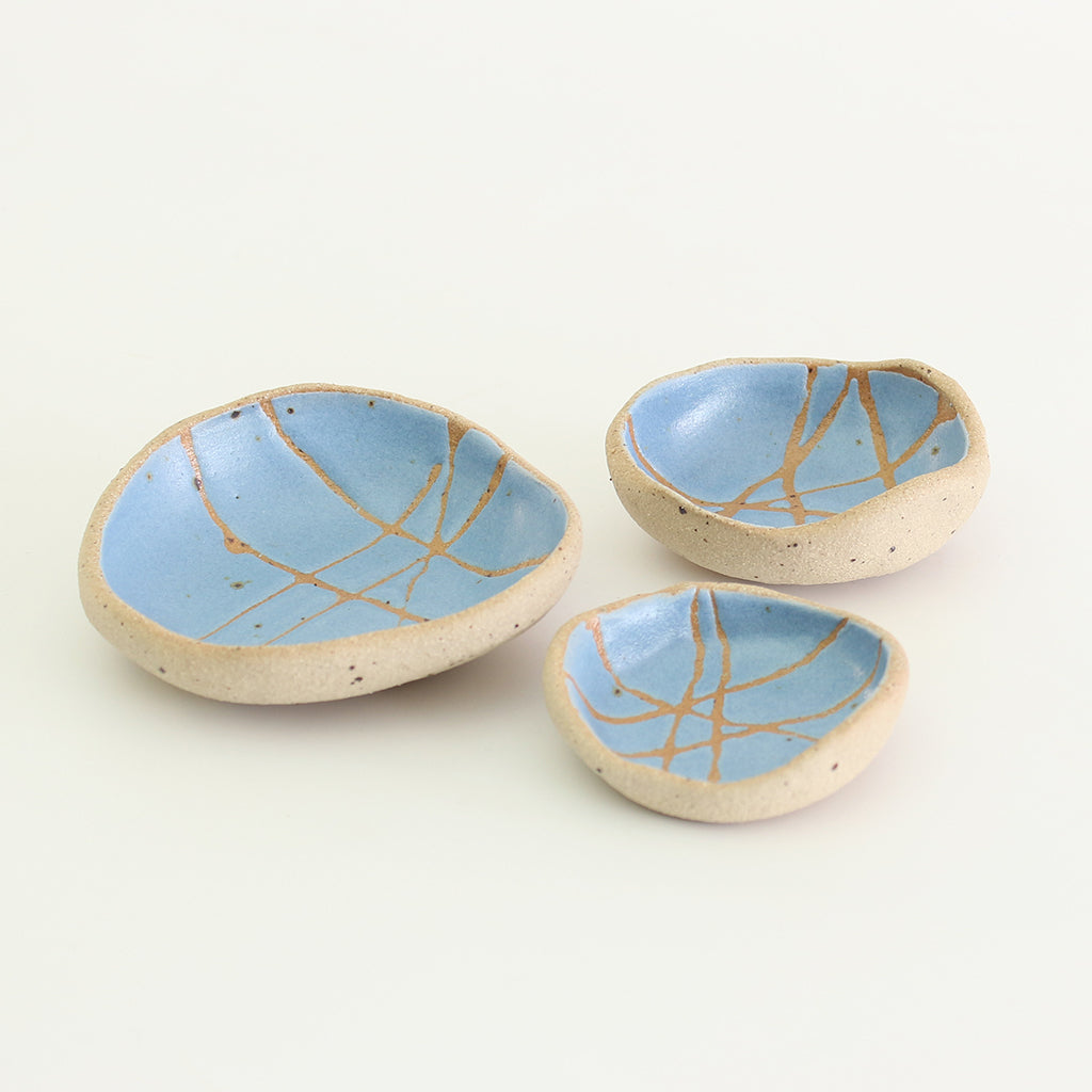 Internal blue patterned bowls in mini, small and medium sizes with raw clay exteriors