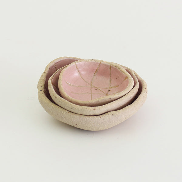 Mini and small patterned pale pink wonky bowls stacked inside medium wonky bowl