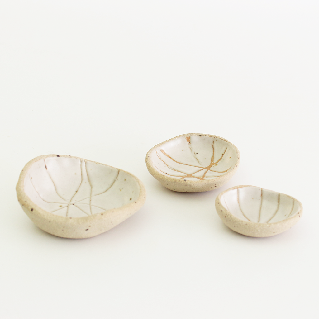 Internal white patterned bowls in mini, small and medium sizes with raw clay exteriors