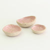 Internal pink patterned bowls in mini, small and medium sizes with raw clay exteriors