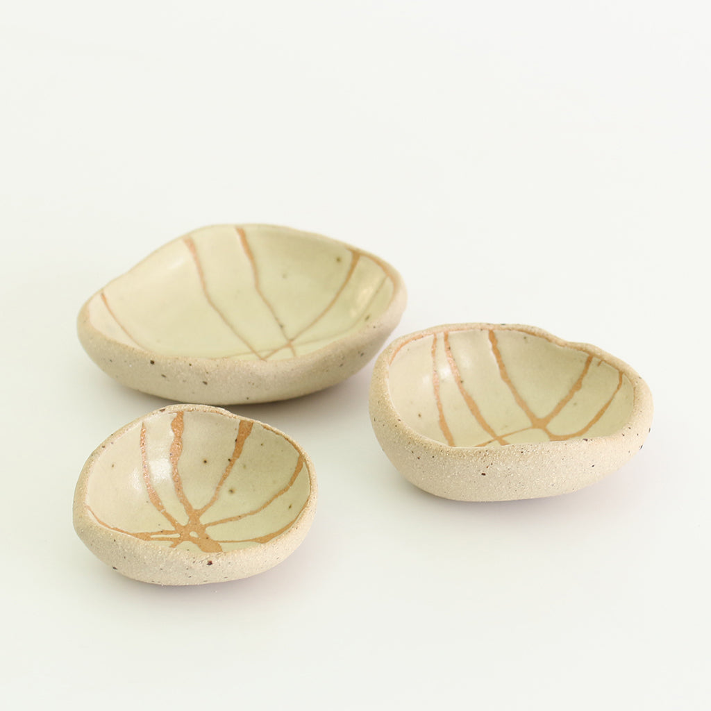 Internal yellow patterned bowls in mini, small and medium sizes with raw clay exteriors