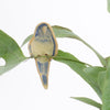 small ceramic and glass dark blue budgie plant decoration, with thin wire feet wrapped around house plant stem