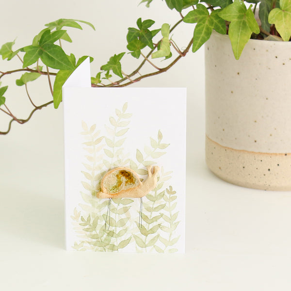 gift card with watercolour leaves design and ceramic plant hugger in the centre