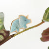 small ceramic and glass aqua blue triceratops dinosaur plant decoration on plant stem