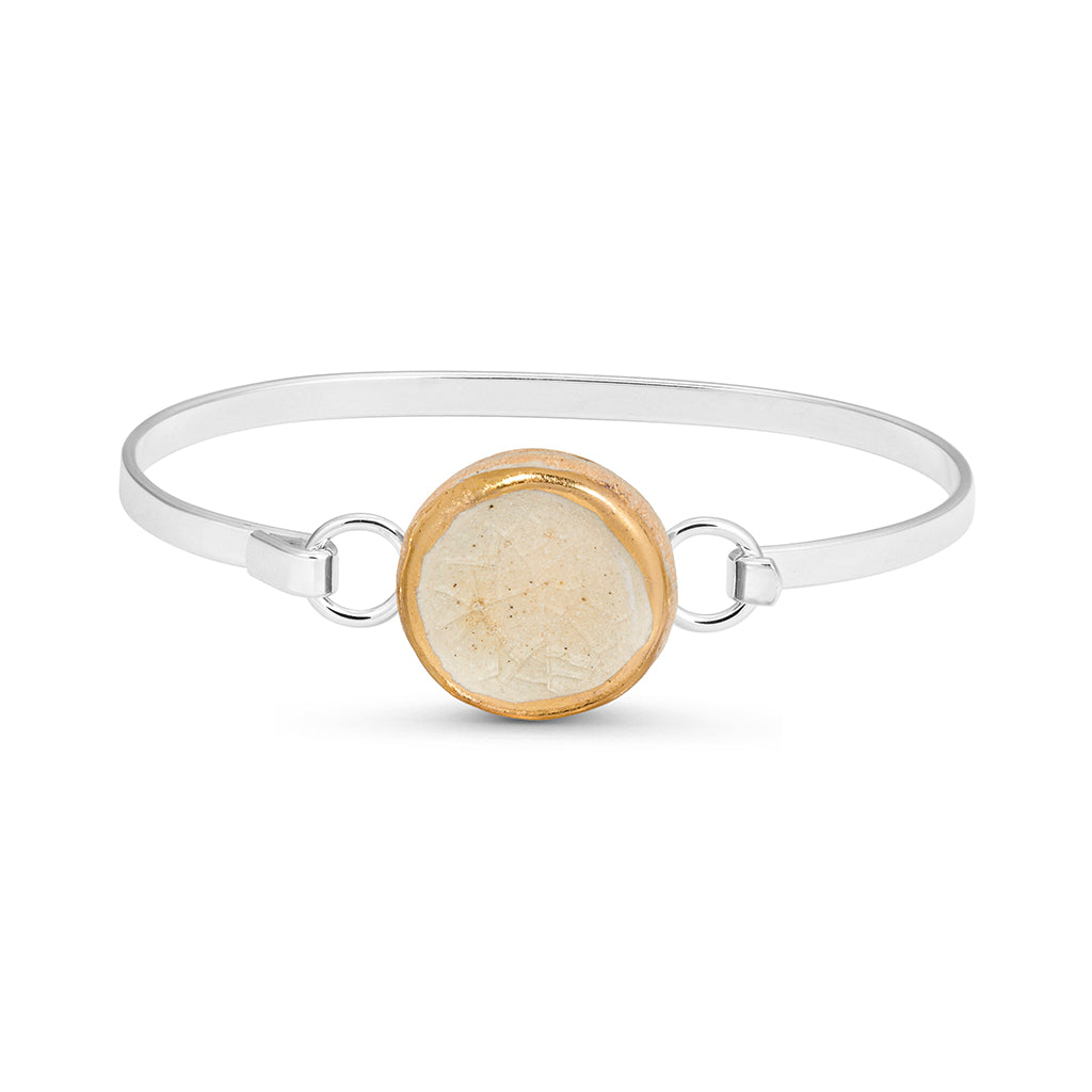 Crystal clear crackled glass round charm outlined in gold lustre on a silver plated latch bangle