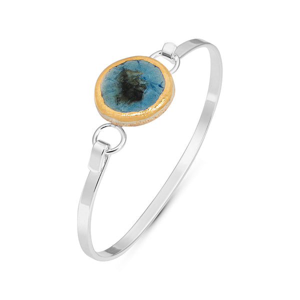 Side view of blue reef crackled glass round charm outlined in gold lustre on a silver plated latch bangle