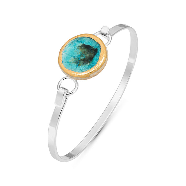 Side view of turquoise reef crackled glass round charm outlined in gold lustre on a silver plated latch bangle